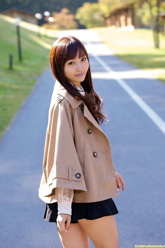 Woman in trench coat on a path