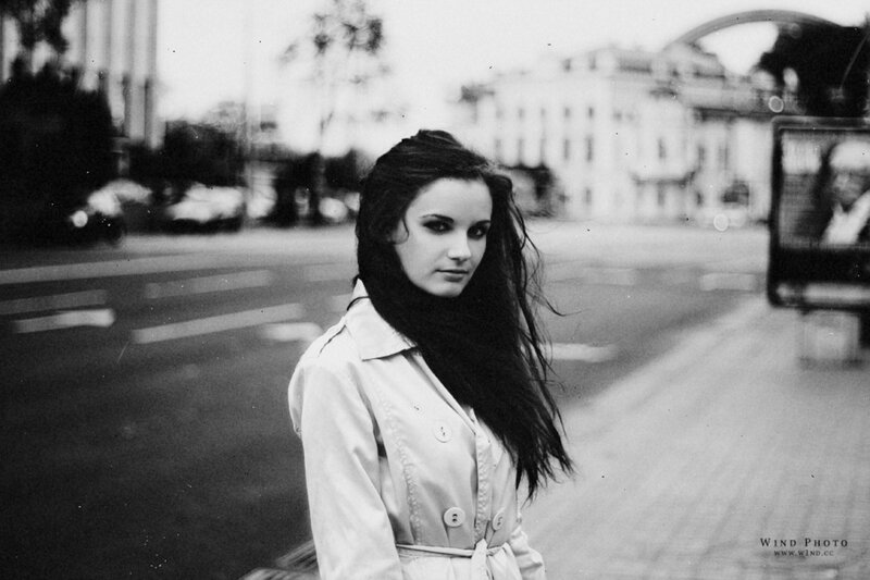 woman in trench coat on street