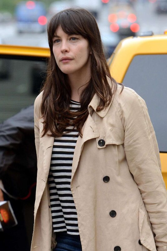 woman in trench coat on street