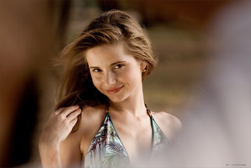 woman in tropical top smiling