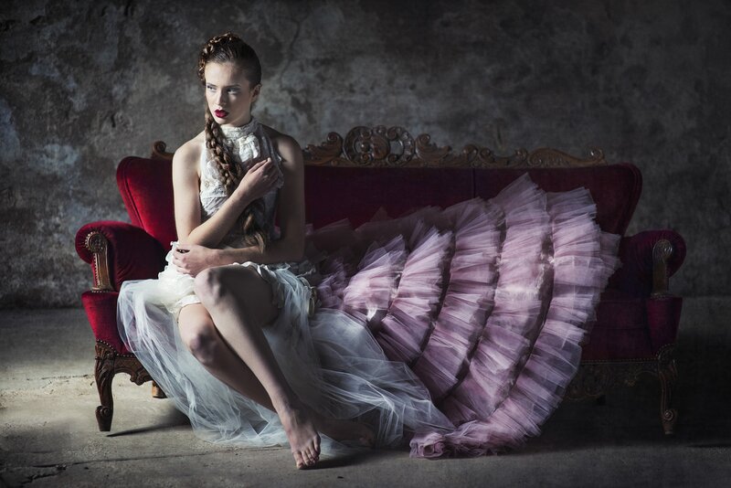 Woman in Tulle Dress — White, Dramatic, Photograph, Red Couch