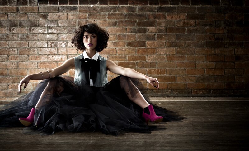woman in tulle skirt sitting on floor