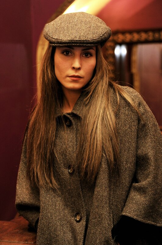 woman in tweed coat and cap