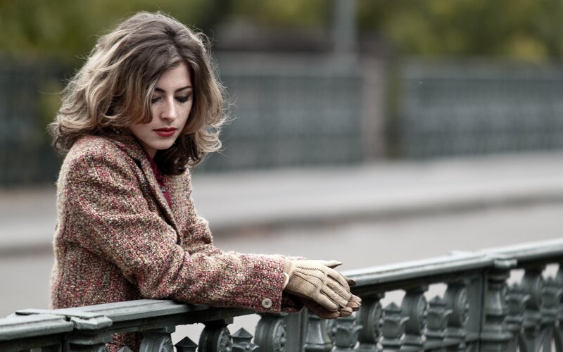 woman in tweed coat on bridge