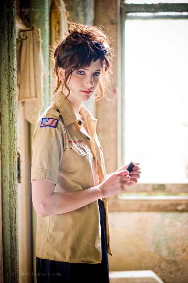 woman in uniform by window