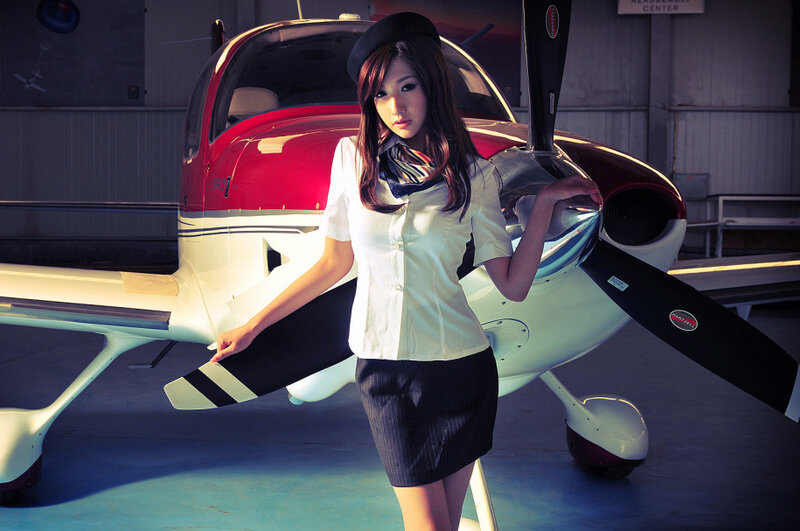 woman in uniform near airplane