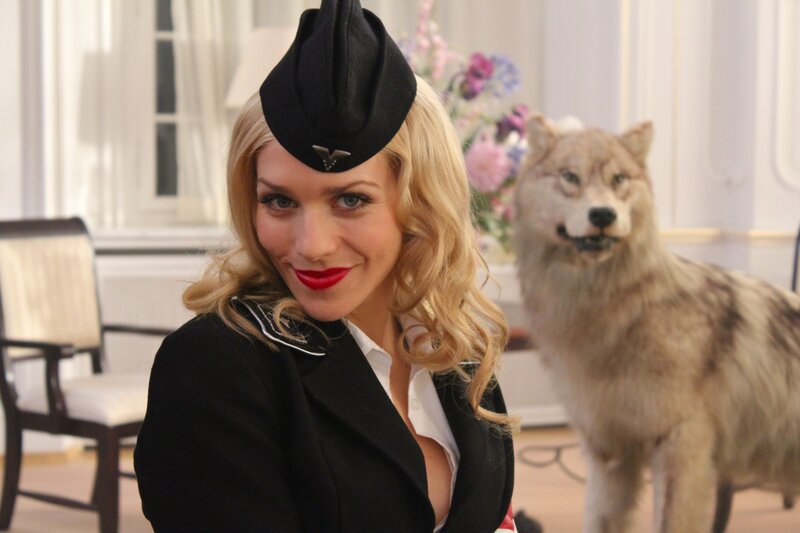 Woman in uniform with wolf statue