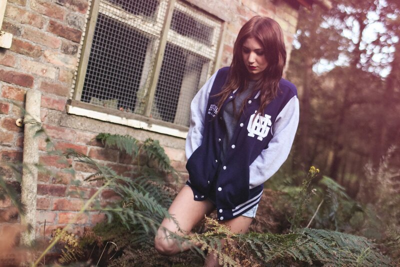woman in varsity jacket outdoors