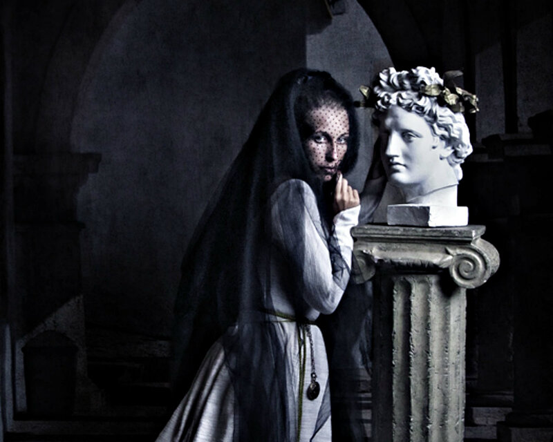 Woman in Veil Beside Statue