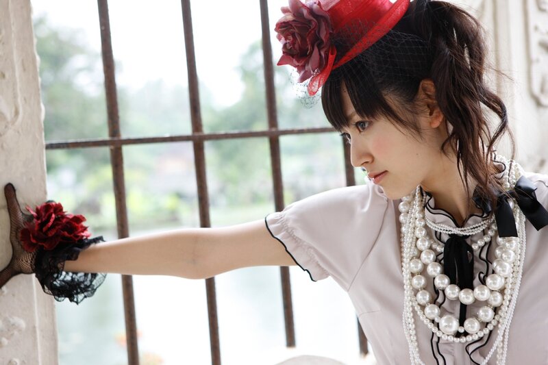 woman in vintage attire by window