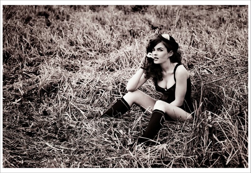 woman in vintage attire sitting in field