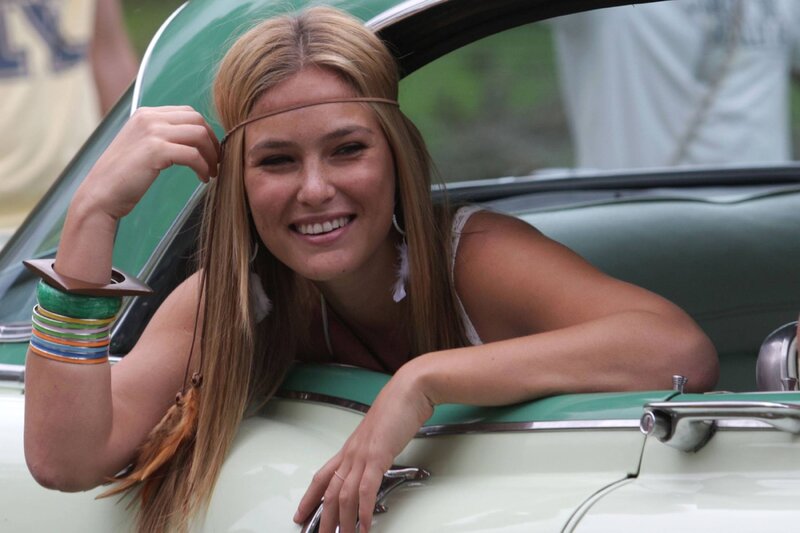 woman in vintage car smiling