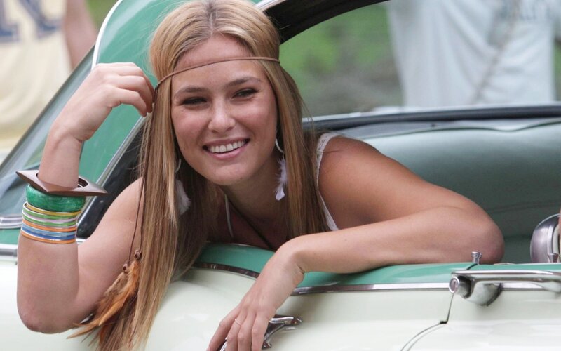 woman in vintage car smiling