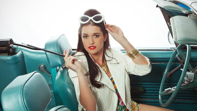 woman in vintage car with sunglasses