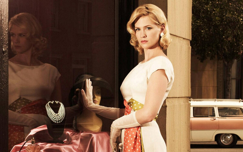 woman in vintage dress by shop window