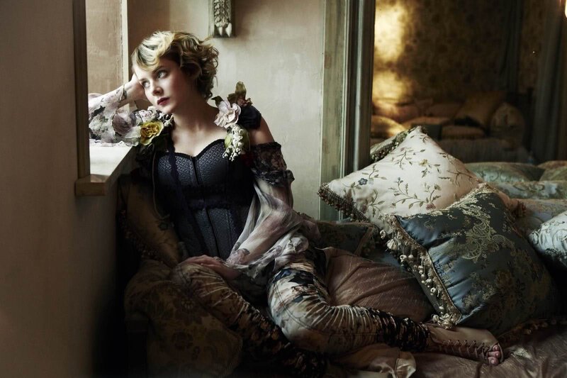 woman in vintage dress by window