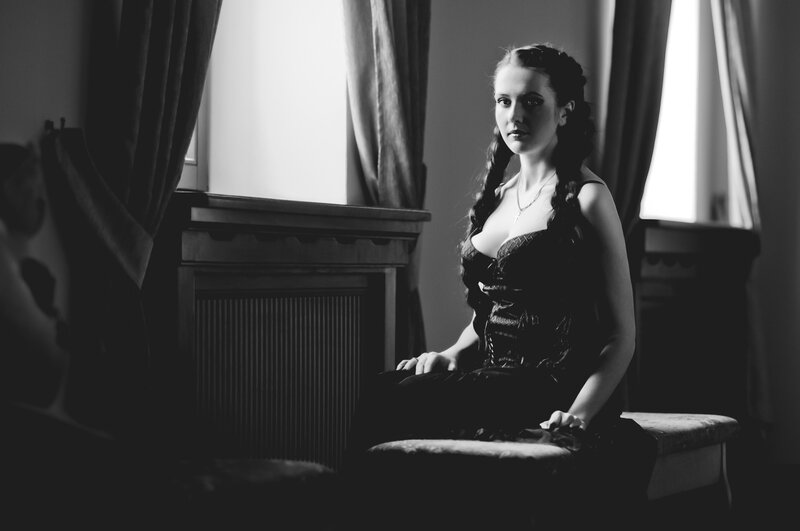 woman in vintage dress by window