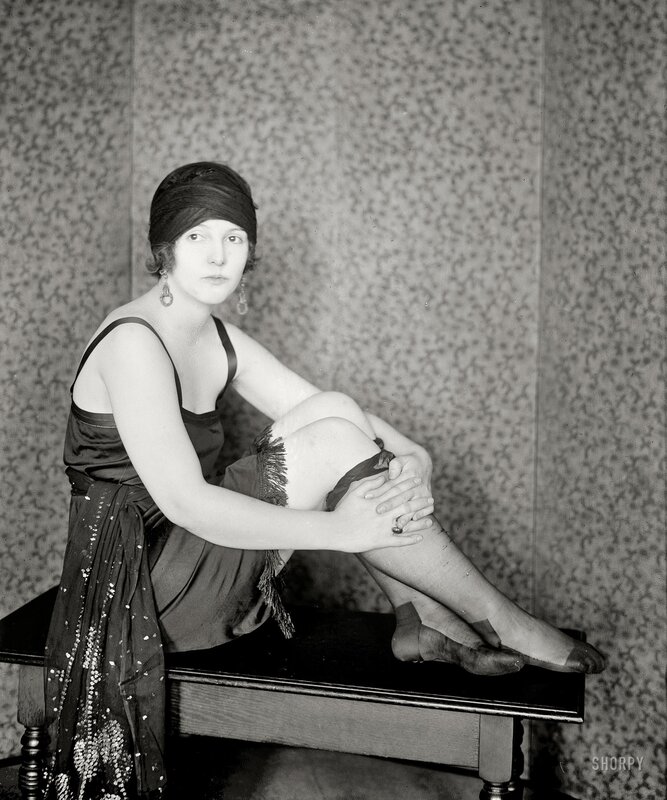 Woman in vintage dress sitting on bench