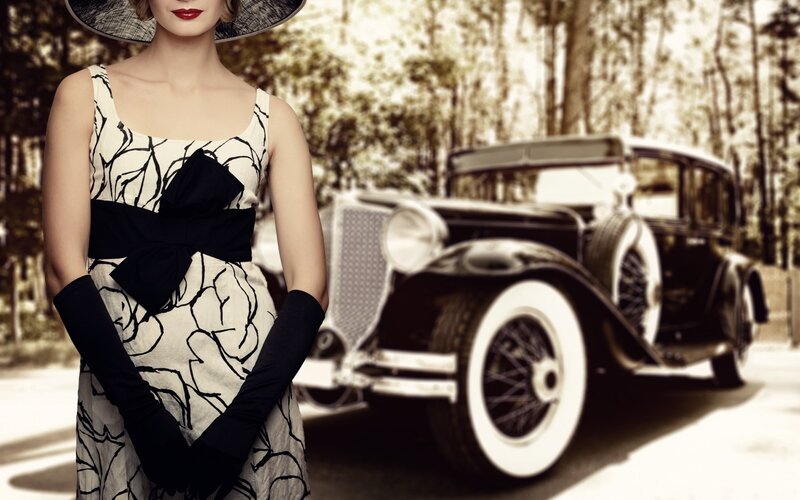 Woman in vintage dress with classic car