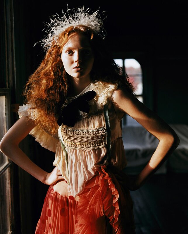woman in vintage dress with feather crown