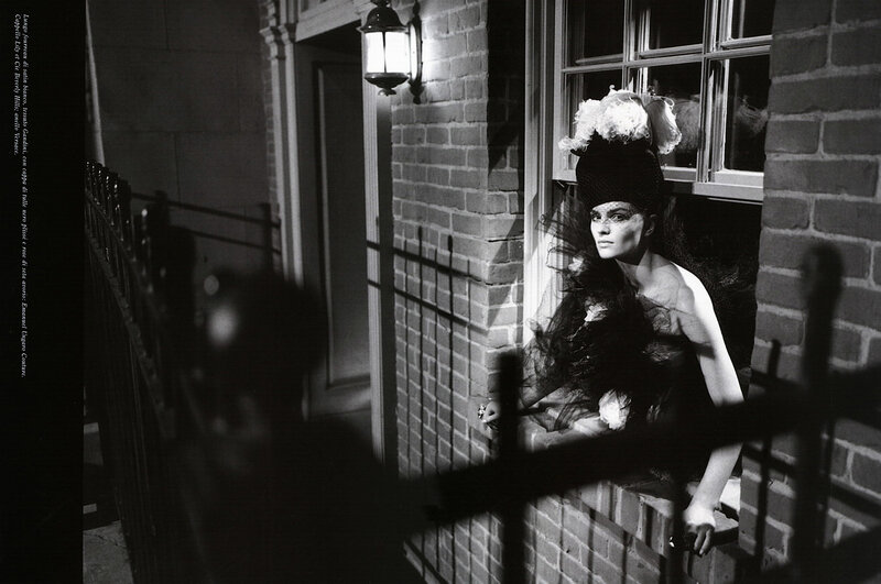 Woman in vintage hat at window
