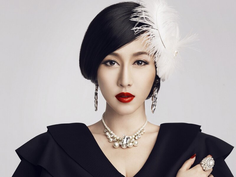 woman in vintage style with feather hat