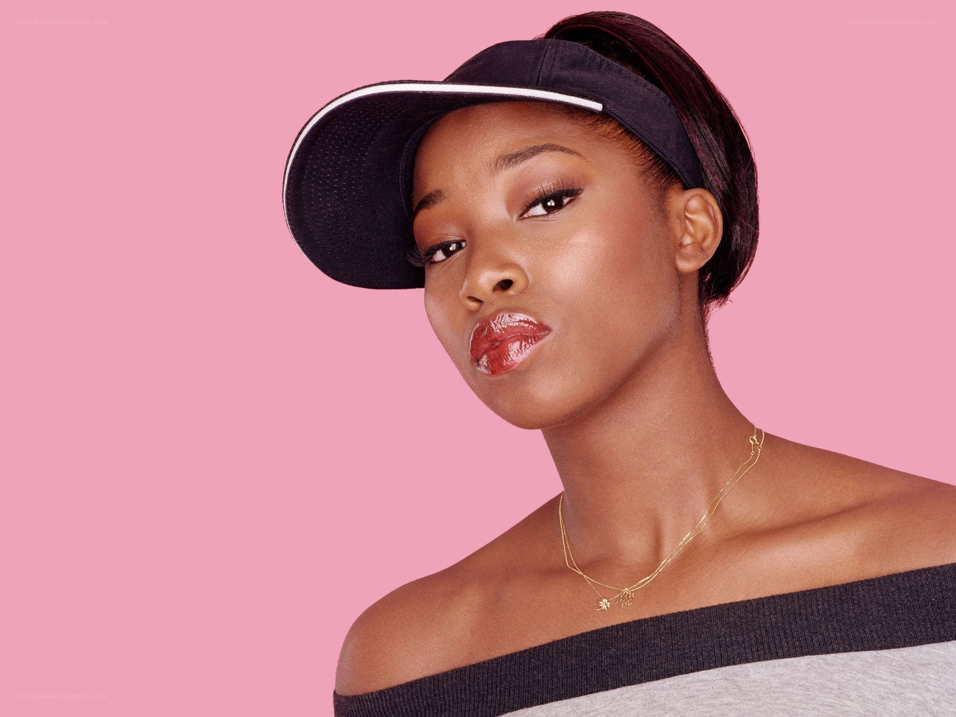 woman in visor on pink background