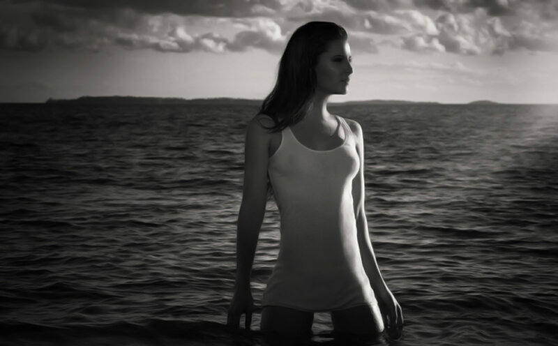 woman in water at sunset