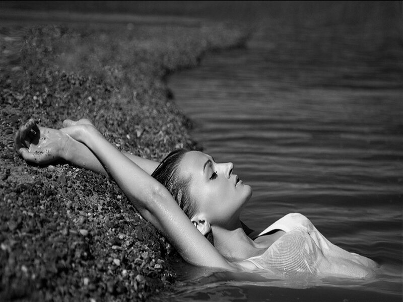 Woman in Water — Black, Serene, Photograph, Pebbles