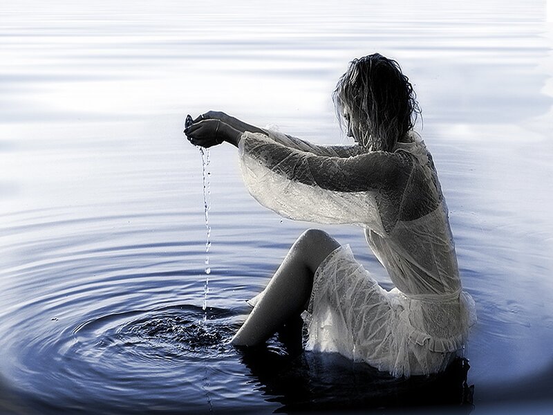 woman in water pouring liquid