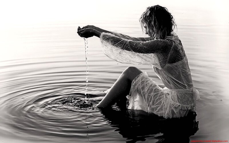 woman in water pouring liquid
