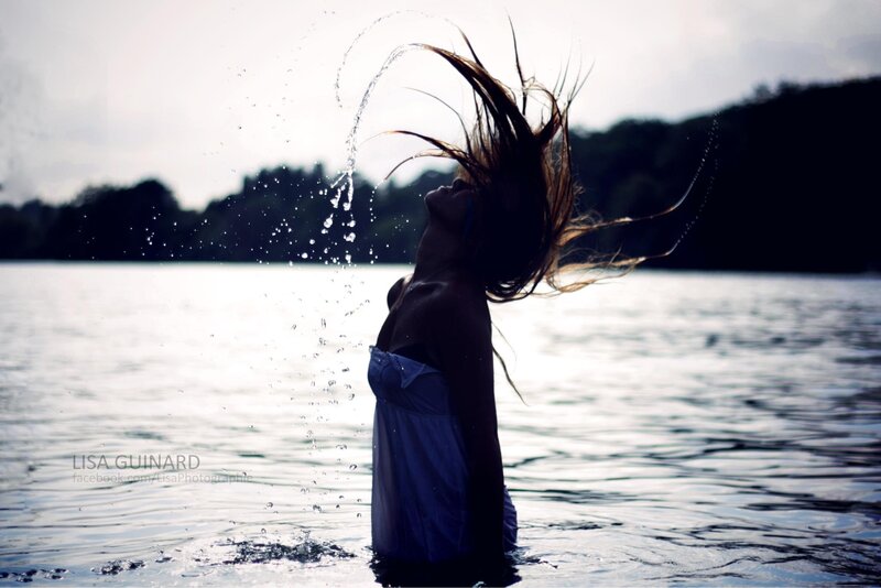 woman in water splashing hair
