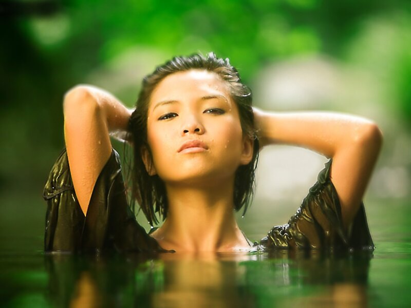 woman in water with green background
