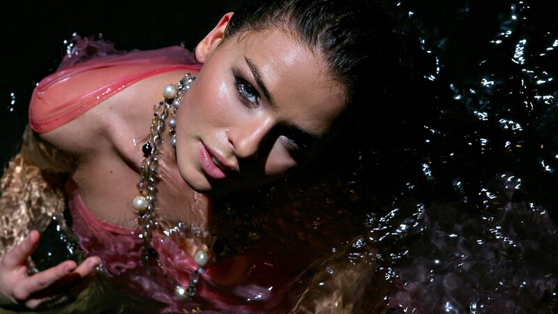 woman in water with pearls