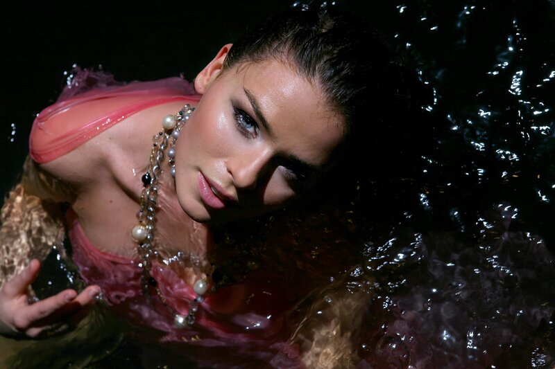 woman in water with pearls