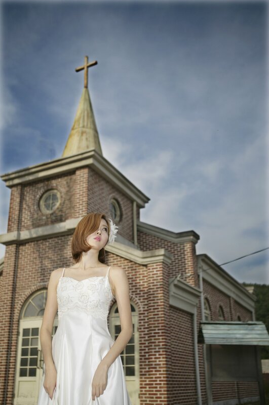 Woman in wedding dress at church