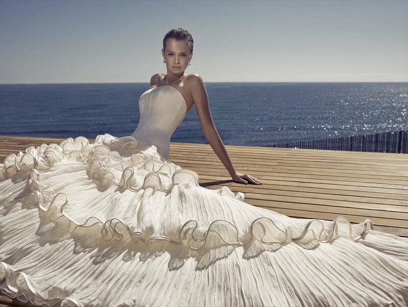 Woman in wedding dress by the sea