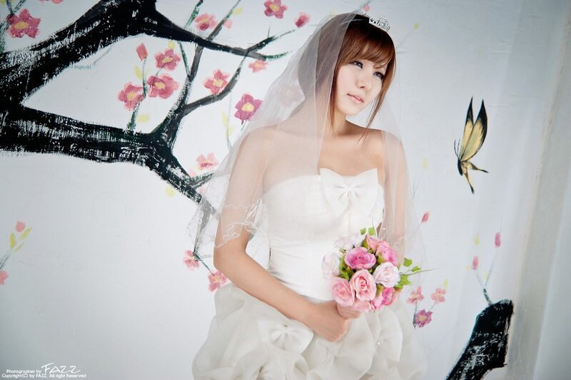 woman in wedding dress holding bouquet
