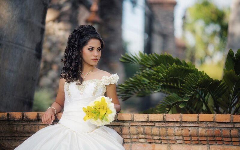 woman in wedding dress holding bouquet