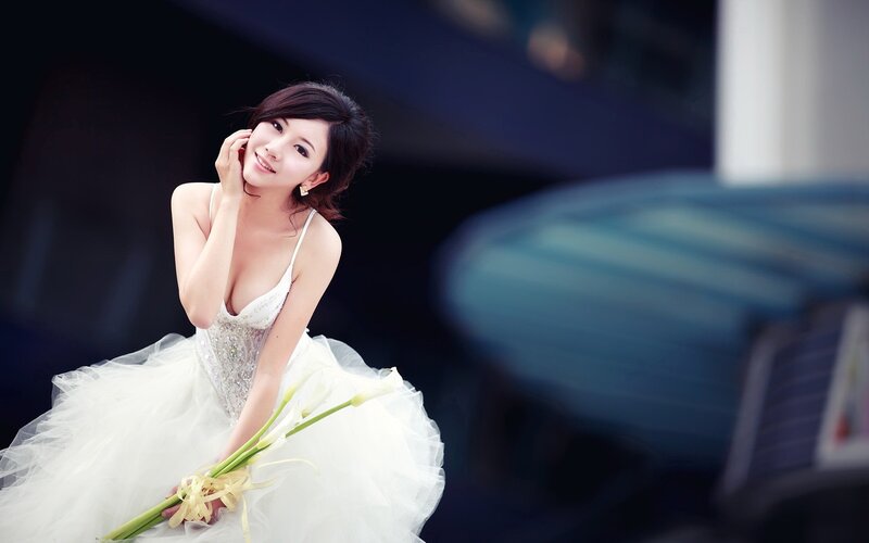 woman in wedding dress holding flowers