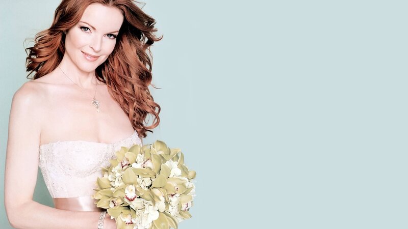woman in wedding dress holding flowers