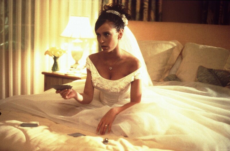 woman in wedding dress on bed