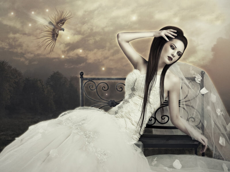 woman in wedding dress on bench