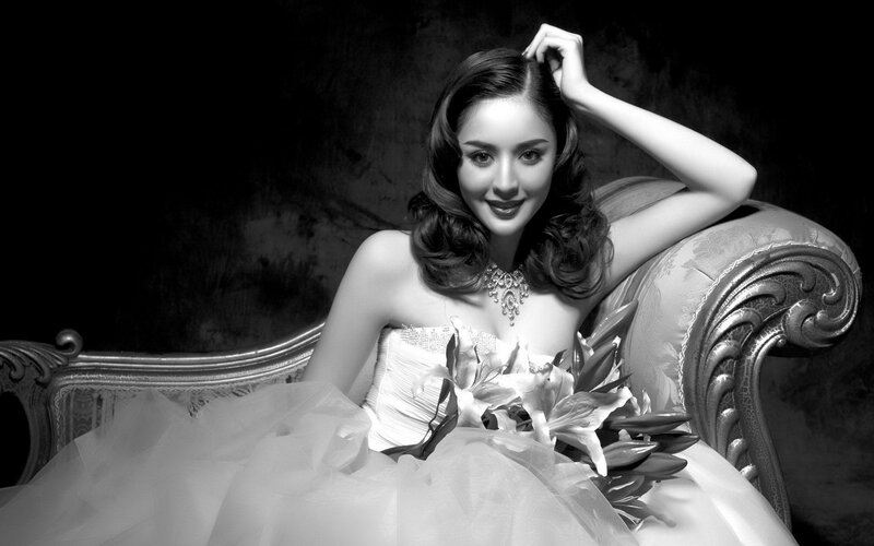 woman in wedding dress on couch