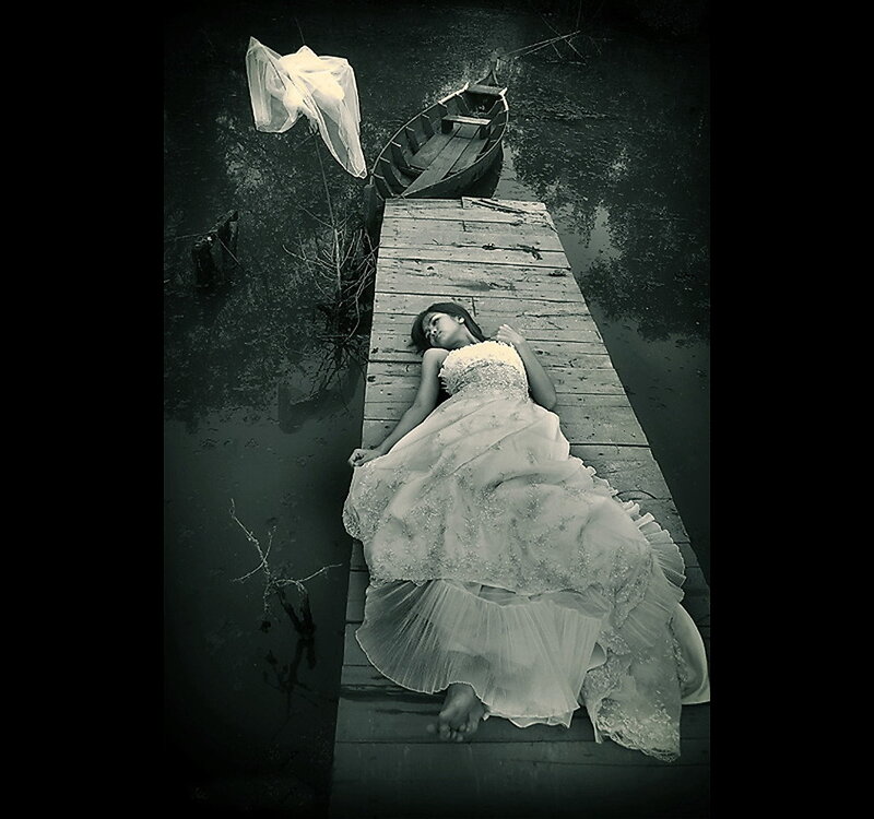 Woman in wedding dress on dock