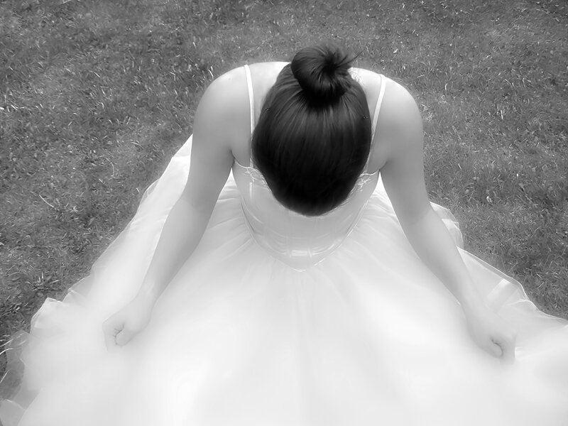 woman in wedding dress sitting