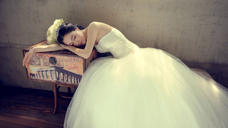 woman in wedding dress sleeping