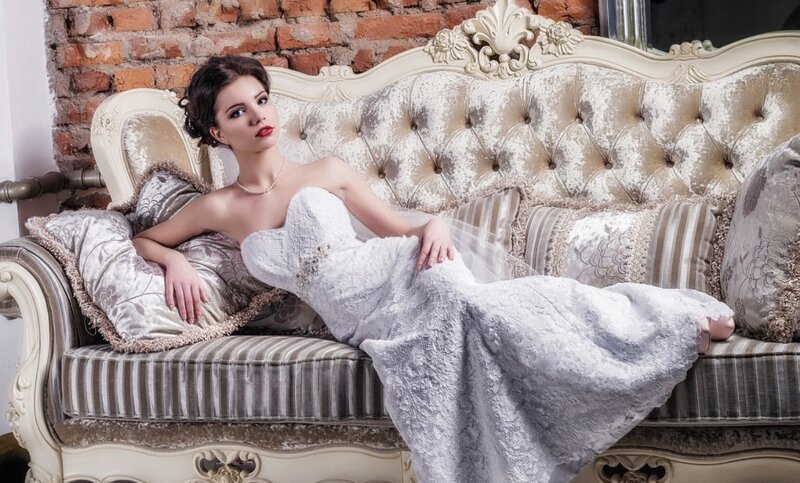 Woman in Wedding Dress — White, Elegant, Photograph, Couch, Brick Wall