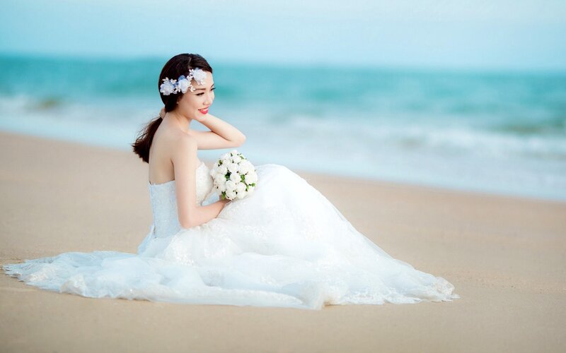 Woman in Wedding Dress — White, Serene, Afternoon, Photograph, Flowers, Bouquet, Beach