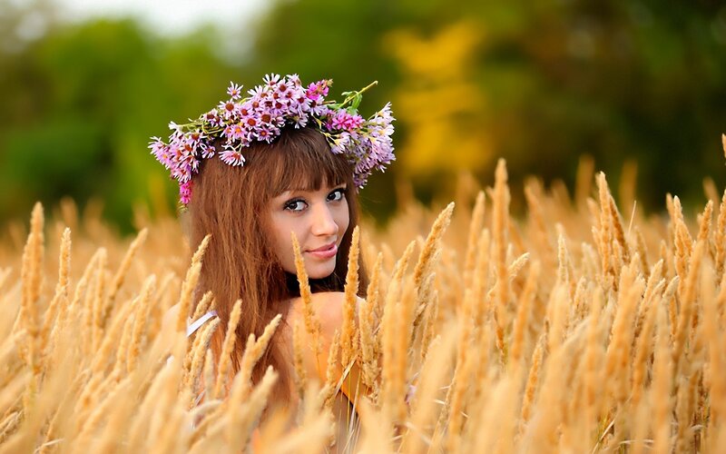 woman in wheat field with flower crown